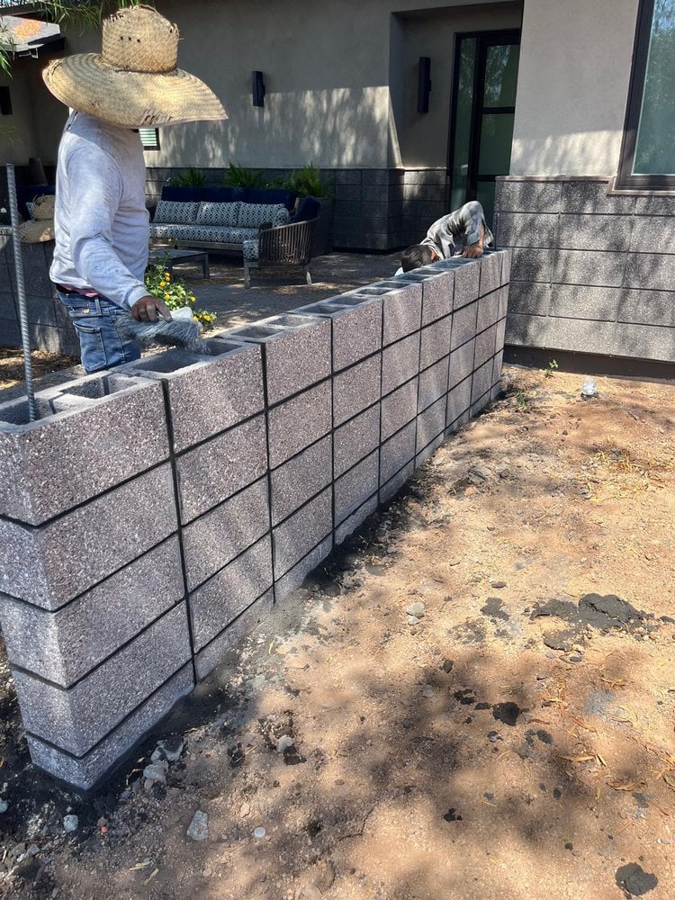 two concrete contractors bending reinforcing steel around a helical pile getting ready to pour some structural foundations at a project in Phoenix AZ
